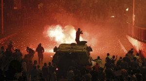 A riot police officer fires rubber bullets at members of the Muslim Brotherhood and supporters of ousted Egyptian President Mohamed Mursi in Cairo