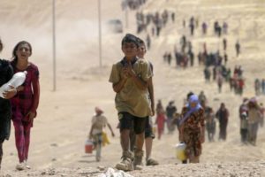 Yazidi children and other refugees in Iraq, walking to the Syrian border.