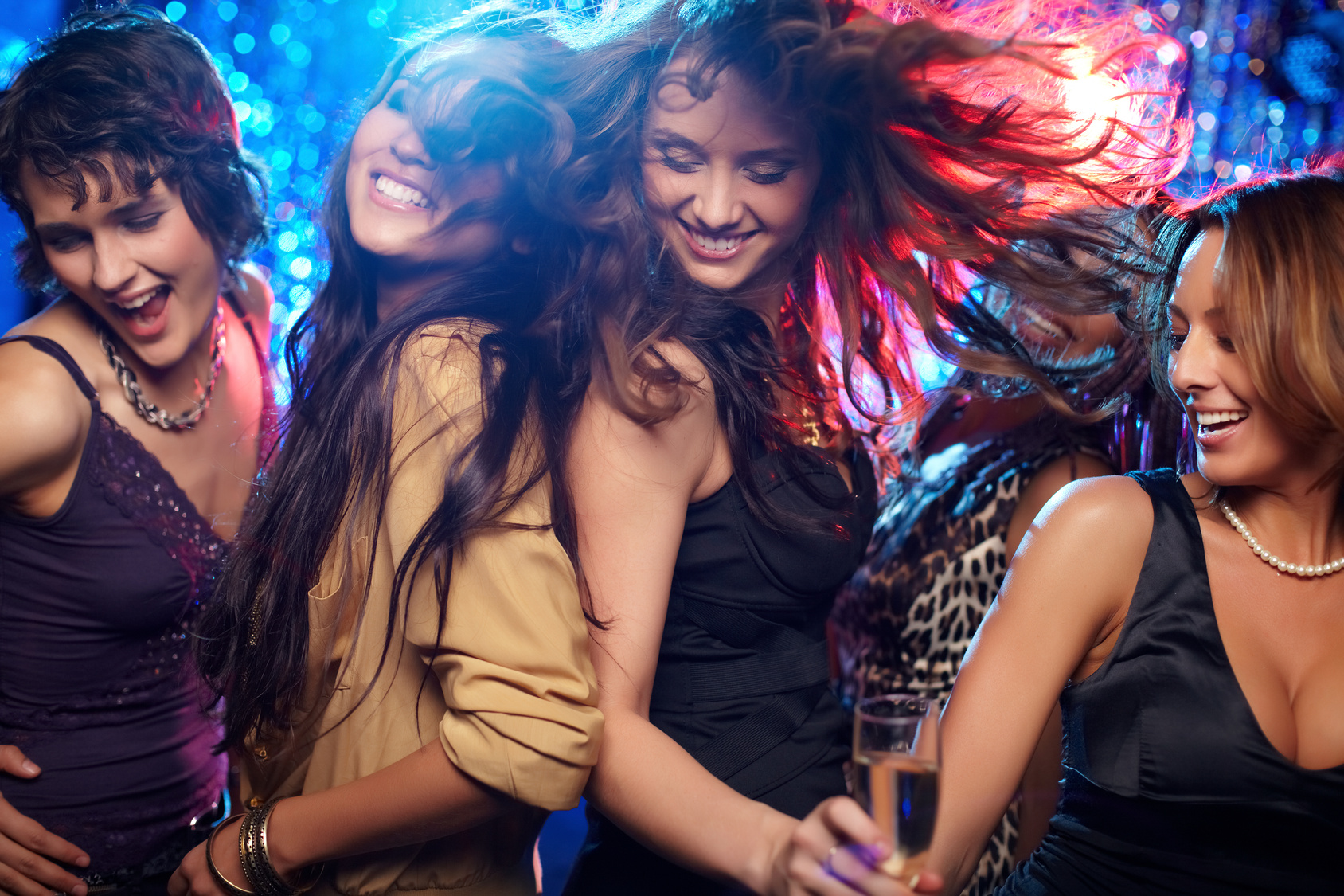Young women having fun dancing at nightclub.