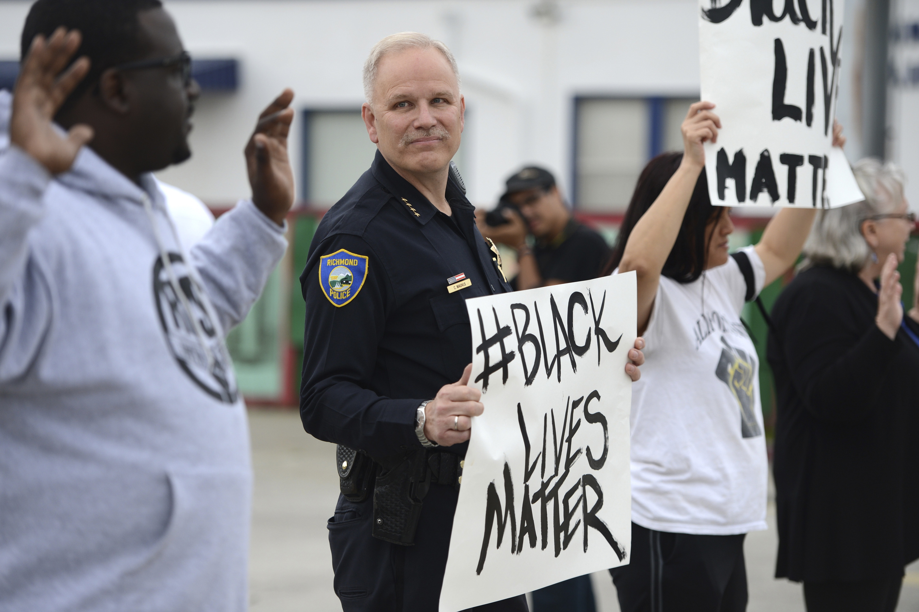 FILE - In this Dec. 9, 2014, file photo, Richmond Chief of Police Chris Magnus stands with demonstrators to protest the Michael Brown and Eric Garner deaths during a peaceful demonstration in Richmond, Calif. In cities and states nationwide, police departments are already altering policies and procedures to temper concerns about police conduct in the aftermath of recent cases of black males dying at the hands of white officers. (AP Photo/Bay Area News Group, Kristopher Skinner, File)